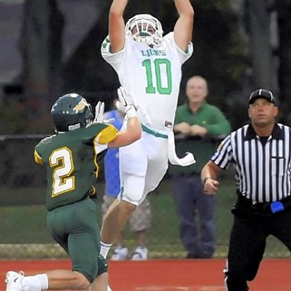 South Fayette's Zach Challingsworth pulls in a touchdown pass as he's defended by Seton-LaSalle's Tom Rizza Friday night.