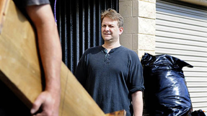 Col. Barry Wingard watches as furniture is loaded onto a U-Haul for his move to Washington, D.C.