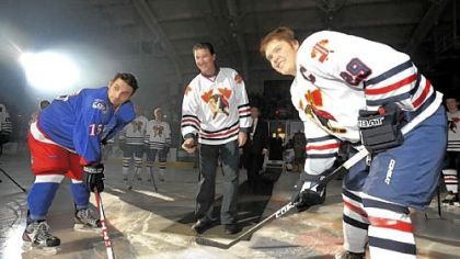 Penquins Mario Lemieux drops the ceremonial first puck Saturday at the Johnstown Tomahawks' first home game at Cambria County War Memorial Arena in Johnstown. At left is the Michagan Warriors' Martin Gruse, and at right is Johnstown's Mitch Kontny.
