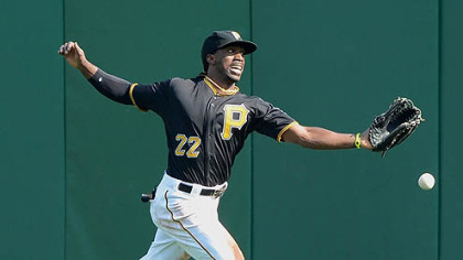 Pirates center fielder Andrew McCutchen cannot run down a ball hit by the Reds' Miguel Cairo for a double.