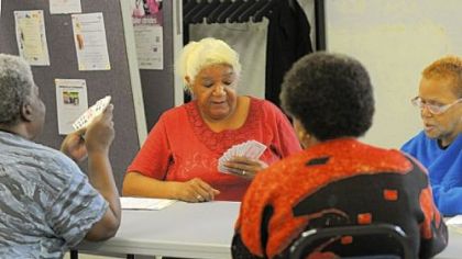 Lillian Hill pauses to decide a play during a card game with (clockwise) Lillie Davis, Lillie James and Alice Hanner at Lemington Community Services in Lincoln-Lemington.