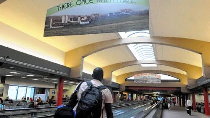Travelers walk through the terminal at Pittsburgh International Airport, which opened 20 years ago.