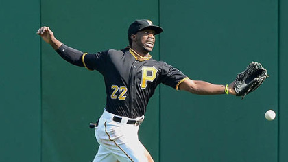 Pirates center fielder Andrew McCutchen cannot run down a ball hit Sunday by the Reds' Miguel Cairo for a double.