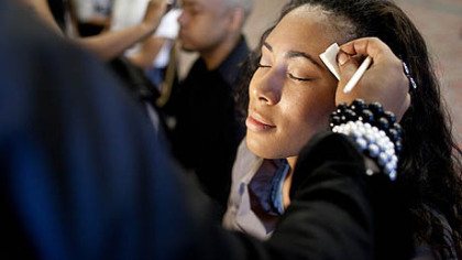 Violet Graham, a model for C. Brown Custom Clothiers designed by Carly Brown and Corey Brown, has her makeup applied backstage before a fashion show at the Clarion Hotel & Convention Center in Green Tree.