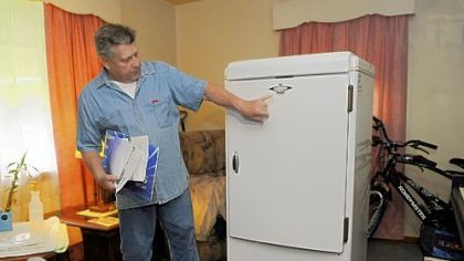 Richard Linnert shows off Pennsylvania's oldest refrigerator at his Baldwin Borough home. Mr. Linnert decided to recycle the appliance, which once belonged to his aunt, through Duquesne Light's Watt Choices program.