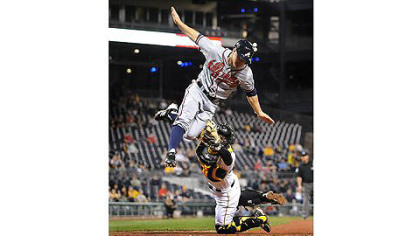 Pirates catcher Michael McKenry tags out high-flying Braves outfielder Reed Johnson at home plate Tuesday at PNC Park.