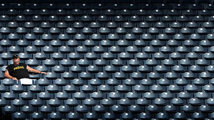 A Pirates fan stretches out along the far third base side during the Bucs final game of the 2012