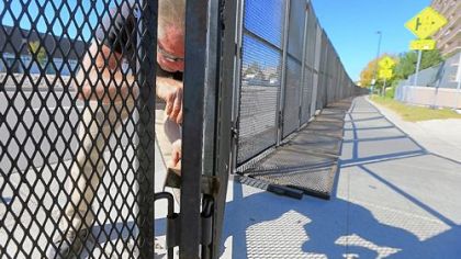 Mark Stahlbaum works on Tuesday on the security perimeter fence in preparation for tonight's first presidential debate at the University of Denver.