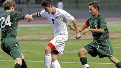 Fox Chapel midfielder Jack Dickens battles for possession with Allderdice's Cameron Fels, left, and Xavier Kandler.