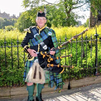 Bagpiper Neil MacLure wearing MacLure tartan.