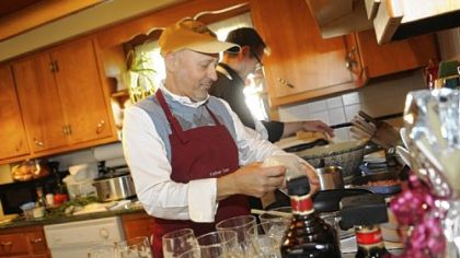 The Rev. Sam Esposito, of St. John the Baptist Parish, prepares risotto for a dinner for the Robino family in Monaca after they won his services in a benefit auction. Helping him is his sous chef, Mike Matta.