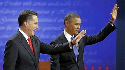 Republican presidential nominee Mitt Romney and President Barack Obama wave to the audience during the first presidential debate at the University of Denver.