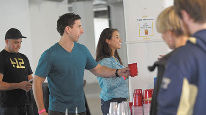 Tapped Pop-up Beer Garden held by Bar Marco and Epic Development at Bakery Square in East Liberty. From left, Kevin Cox, Skye Frontier and Abbie Maravalli wait on customers.