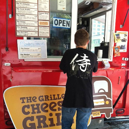 Filling up a teenager at a popular Food Cart in Portland. Oscar waits for his sammie.
