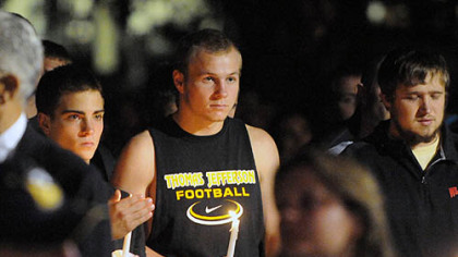 Washington & Jefferson football team member, freshman Ryan Ruffing, holds a candle at a vigil for slain teammate Tim McNerney.