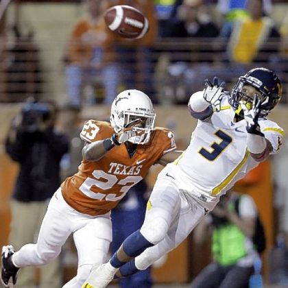 West Virginia's Stedman Bailey leaps for a touchdown pass as Texas' Carrington Byndom defends during the third quarter.