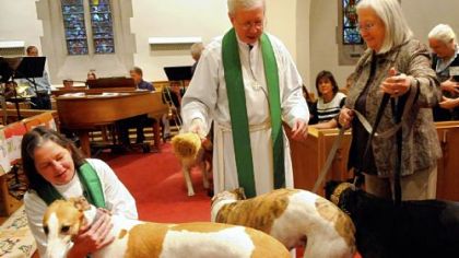 During the October 2009 Blessing of the Animals for the feast of St. Francis, the Rev. Mabel Fanguy corrals Toni Frey's greyhounds (from left: Cecil, Frankie and Doc) so the Rev. Louis Hays, rector, can bless them at the altar of St. Paul's Episcopal Church in Mt. Lebanon.