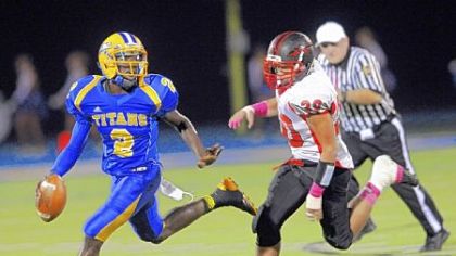 West Mifflin quarterback Derrick Fulmore runs against Elizabeth Forward's Anthony Hill Friday at West Mifflin High School