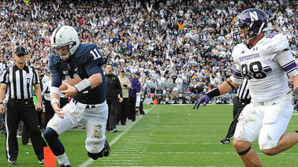 Penn State quarterback Matt McGloin leaps in to the end zone scoring the game-winning touchdown against Northwestern in today's game at State College.