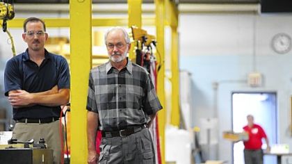 Billet Industries president Troy Billet stands with his father and company CEO Keith Billet in their shop at Billet Industries.