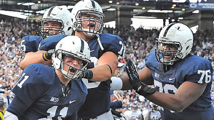 Penn State quarterback Matt McGloin, left, is congratulated by teammates after he scored the game-winning touchdown against Northwestern Saturday  afternoon at Beaver Stadium in State College.