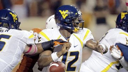 West Virginia's Stedman Bailey (3) leaps for a touchdown pass as Texas' Carrington Byndom (23) defends in the third quarter Saturday night in Austin, Texas.