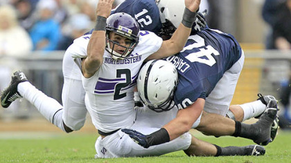 Northwestern quarterback Kain Colter is tackled by Penn State cornerback Stephon Morris and linebacker Glenn Carson during the second quarter at State College.