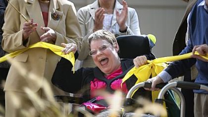Resident Karen Bitzer celebrates Thursday at the opening of the Sensory Garden at Allegheny Valley School's Patricia Hillman Miller Campus in the West End.