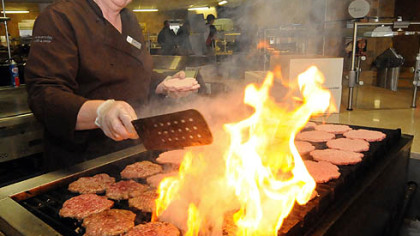 Shelby Lehman makes made-to-order burgers on the grill at Shippensburg University's Reisner Dining Hall.