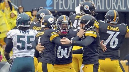 Shaun Suisham is congratulated by teammates Greg Warren and Drew Butler after kicking the winning field goal against the Eagles in the fourth quarter Sunday at Heinz Field.
