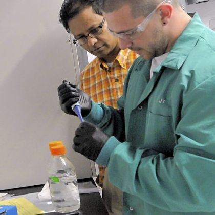 Duquesne University professor Partha Basu, left, who has studied arsenic contamination in food, observes grad student John Thomas prepare compounds to be analyzed.