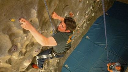 A student scales the rock-climbing wall at Clarion University's Student Recreation Center.