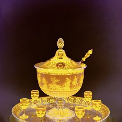 Baccarat exhibited this lidded punch bowl with goblets, tray and ladle, made around 1867, at the Paris world's fair that year. Made in the neo-Grecian style, the scene on the bowl was made with acid etching.