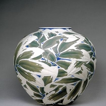 Itaya Hazan's training as a sculptor is clear in this carved porcelain vase that Henry Walters bought at the 1915 Panama-Pacific International Exposition held in San Francisco. Hazan's shallow relief of overlapping bamboo leaves are heightened by dark green and blue stains with a pure white matte finish.