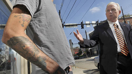 Pennsylvania Auditor General Jack Wagner, right,  stands in front of  Rogue Tattoo  in Lawrenceville with shop owner Travis Courtemanche.