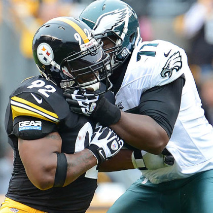 Steelers James Harrison battles with Eagles tackle Demetress Bell in Sunday's game at Heinz Field. At one point in the game Harrison pulled up rather than hit Michael Vick because of previous fines from the league.
