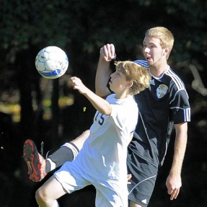 Sewickley Academy's Ben DiNardo, front, goes for the ball against South Side Beaver's Lucas Collett in a WPIAL Class A Section 5 match Tuesday. Sewickley Academy won, 10-0.