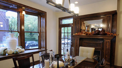 The dining room in Mark and Mary Pent's Shadyside home. Juniper Holdings custom-built the fireplace mantel.