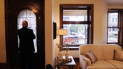 Mark Pent looks out the front door of his Shadyside home toward the front porch, where he enjoys talking with passing neighbors.