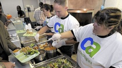 From right, Sue Mangus, Jim Kodoszyunski and Karen Joseph, volunteers from CA Technologies, spend their volunteer day Wednesday serving meals at the Jubilee Kitchen, Uptown. It was the company's seventh annual day of volunteer action.