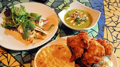Clockwise from left, executive chef Benjamin Sloan's fish tacos, avocado soup and fried chicken with sides at Kaya in the Strip District.