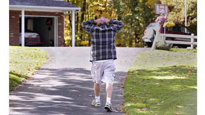 William Proper, father of Zachary Proper, a 13-year-old boy has been charged in the shooting deaths of his grandparents, gathers his thoughts while walking toward the house, where his stepfather and mother lived.