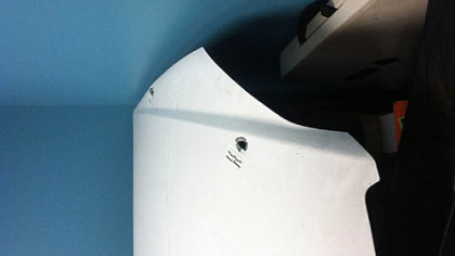 Two bullet holes can be seen in the hood of Officer Andrew Baker's patrol car.