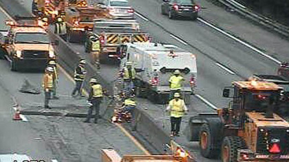 A PennDOT camera shows crews just after sunrise working to clear the crash scene on the Parkway West.