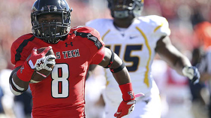 Texas Tech's SaDale Foster breaks free for a touchdown ahead of West Virginia's Eric Kinsey.