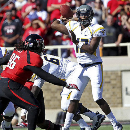 West Virginia's Geno Smith throws under pressure from Texas Tech's Dennell Wesley.