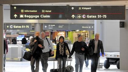 Travelers head to their terminal at the Pittsburgh International Airport. Costs per passenger are increasing for airlines.