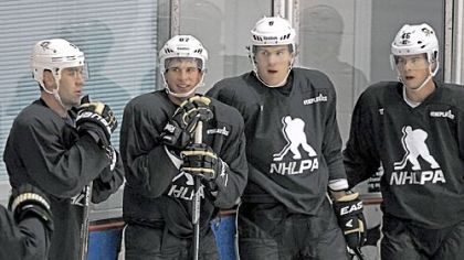 Penguins, from left, Pascal Dupuis, Sidney Crosby, Ben Lovejoy and Tyler Kennedy all wear a sweater displaying NHL Players' Association logo as they pause between drills at an informal workout Thursday at the Iceoplex in Canonsburg.