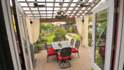 A covered pergola provides a shady place for evening meals in the Kocurs' backyard.
