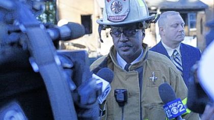 Pittsburgh fire Chief Darryl Jones talks to media Friday at the scene of the fatal Mirror Street blaze. Michael Huss, city public safety director, is at right rear.